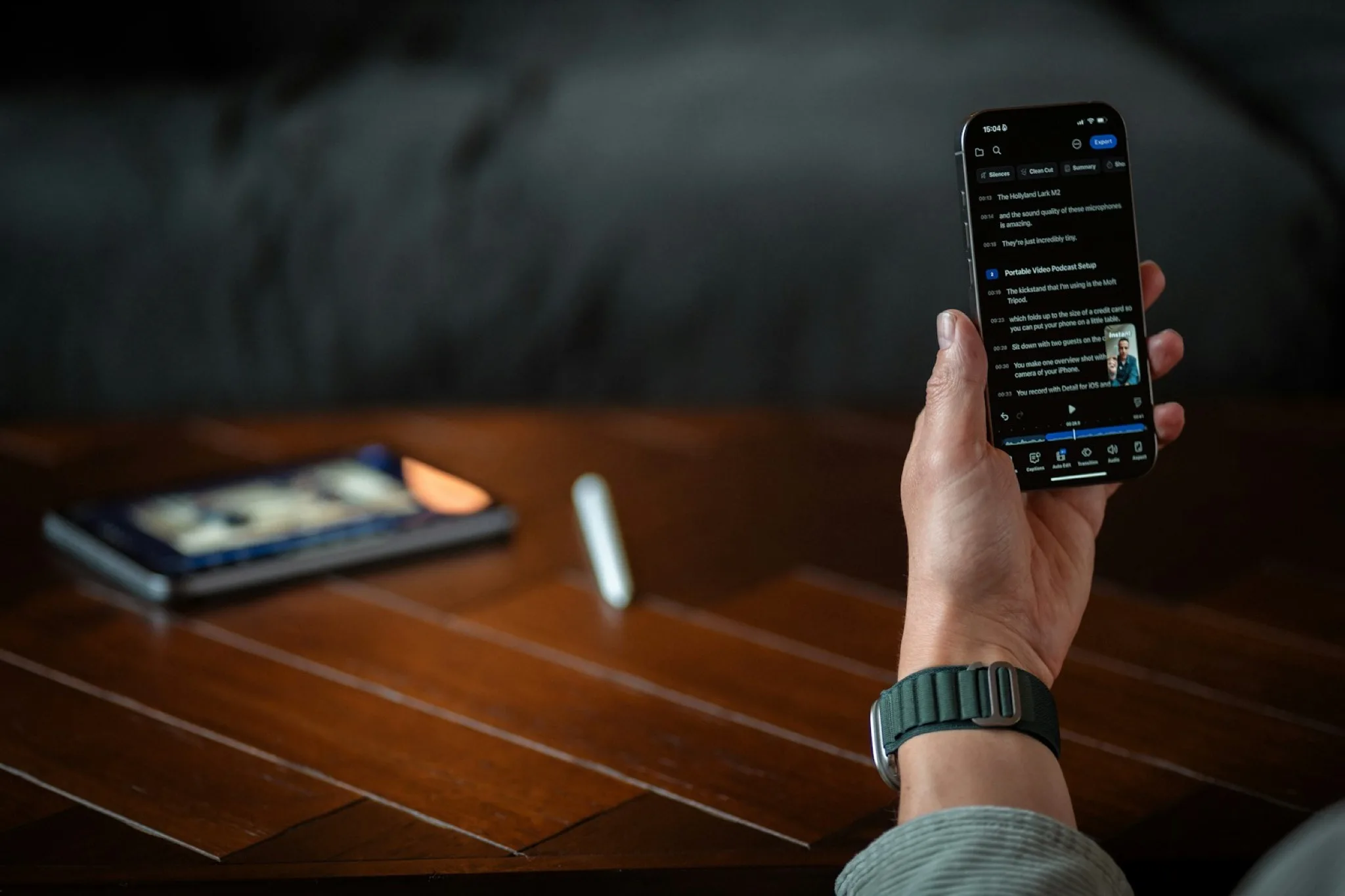 A person holding a smartphone with a dark screen.