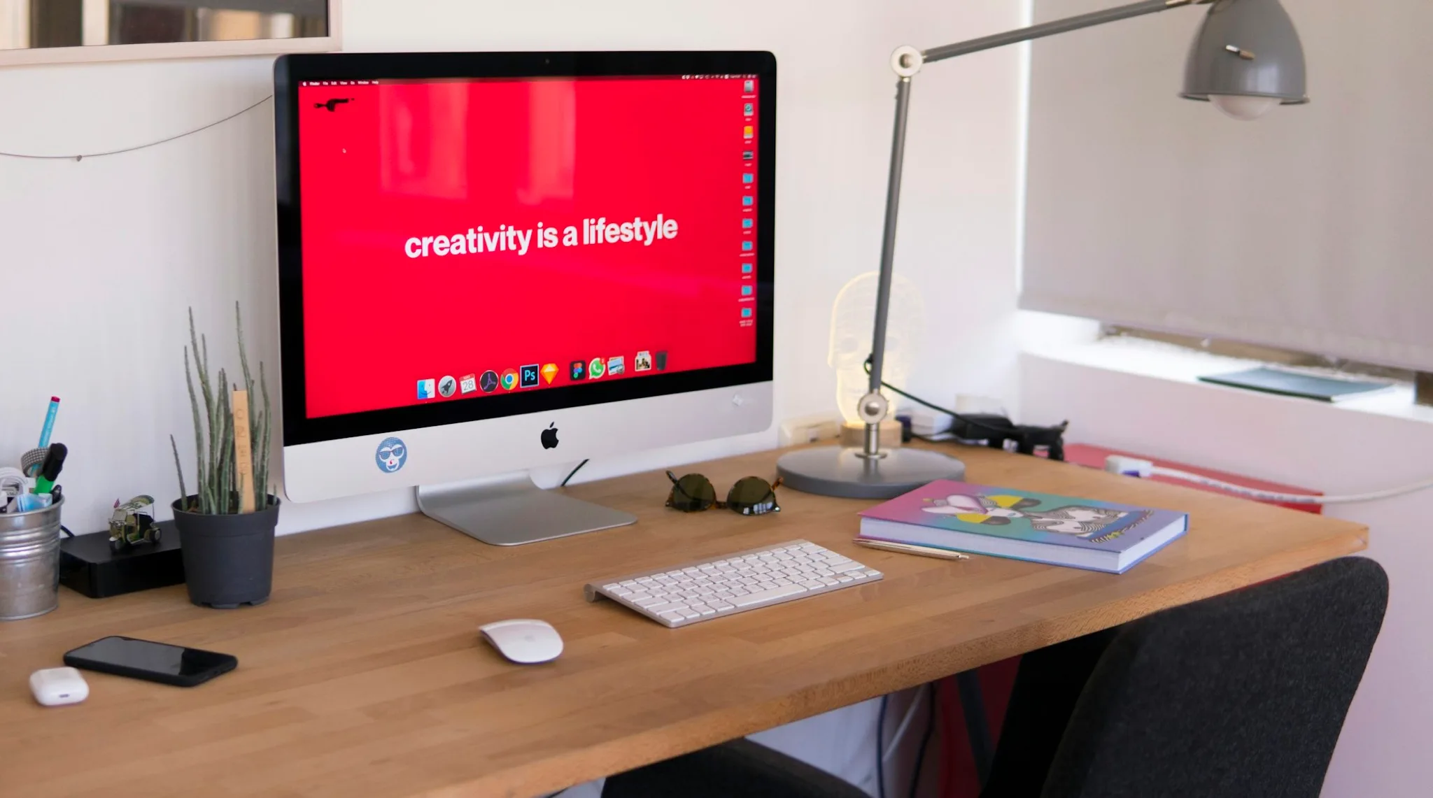 A desktop computer in a red creative studio.